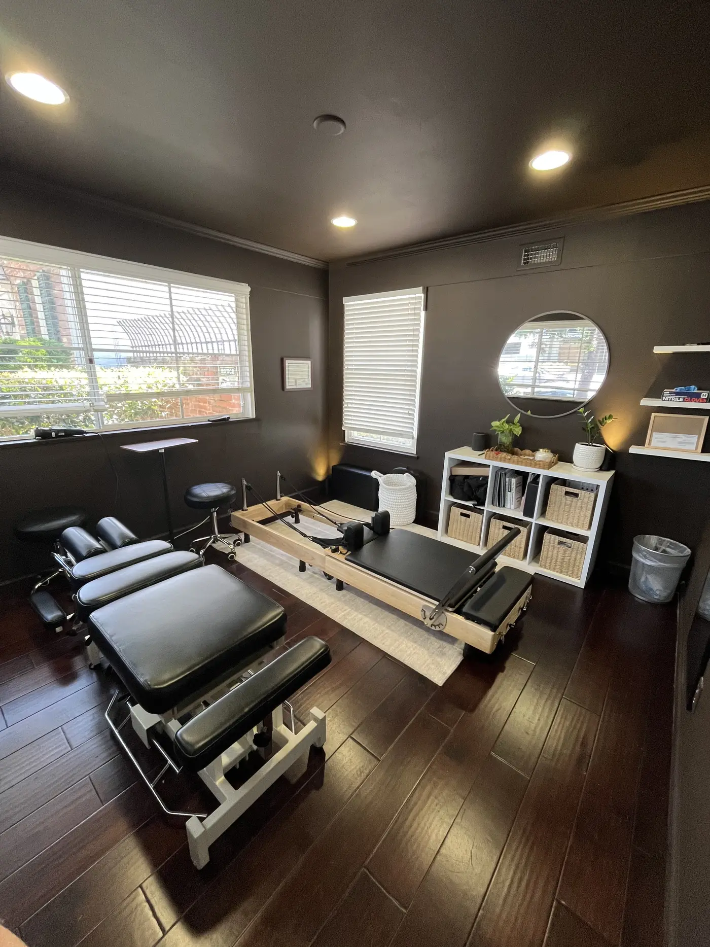 Treatment room at Balanced by V in La Jolla with chiropractic table and Pilates reformer